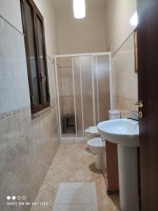 a bathroom with a shower and a sink and a toilet at Villa Etna Masi' in Milo +69 photos
