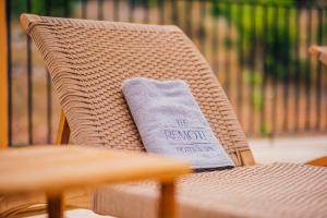a napkin sitting on top of a wicker chair at The Remote Hotel in Sarigerme