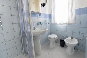 een badkamer met een wastafel, een toilet en een douche bij ONDA MARINA in Agrigento