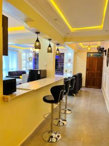 a bar in a waiting room with black chairs at Nitro Homes Nyali in Mombasa