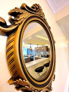a mirror with a dragon on a wall at Nitro Homes Nyali in Mombasa