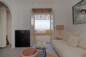 a living room with a couch and a fireplace at Nur Mykonian Suites in Mikonos