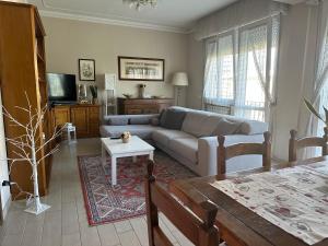 a living room with a couch and a table at Casa Alessia in Lucca