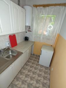 a small kitchen with a sink and a window at Lipowy Przylądek- Domek 13 