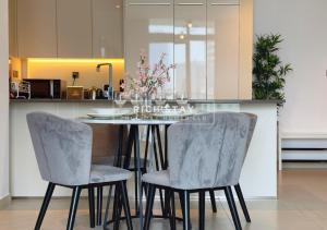 a kitchen with a table and two chairs with flowers on it at Phenomenal 1BR at Marina Gate 2 in Dubai Marina by Rich Stay in Dubai