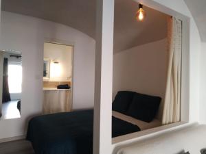 a bedroom with a mirror and a bed at la placette in Hérépian