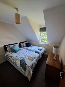 a bedroom with a bed and a window at The Elms Apartments Ramsey Isle of Man UK in Ramsey