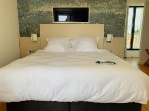 Postel nebo postele na pokoji v ubytování Hôtel Les Mouettes