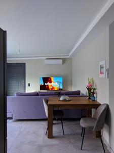 a living room with a table and a couch at LANDR House in Pandokrátor