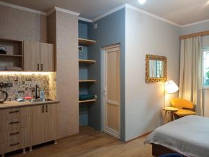 a bedroom with a bed and a sink and a mirror at M55 Home in Batumi