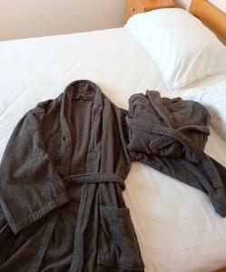 a robe laying on top of a bed at Kat's - Roman Salona in Solin +11 photos