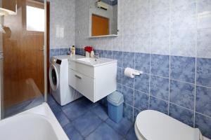 a bathroom with a washing machine and a sink at Apartments Adrian in Bibinje +76 photos