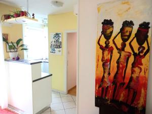 a kitchen with a painting on the wall at Kat's - Roman Salona in Solin