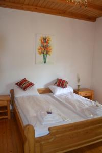 a bedroom with a large bed with two pillows at Heritage home Ustikolina in Foča