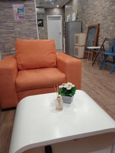a living room with an orange couch and a white coffee table at Dioklecijan delux in Split