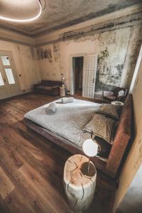 a bedroom with a large bed and a couch at Ruttner Suite in Veszprém