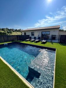 a swimming pool in the middle of a yard at Casa Lamaghjone - Villa T4 avec piscine chauffée à 3,5km de la mer in Aléria