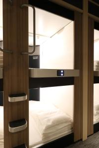 a bunk room with a bed in it at Cabin & Capsule Hotel J-SHIP Osaka Namba in Osaka