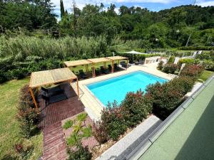 an overhead view of a swimming pool in a garden at Le Village Sarzana in Sarzana