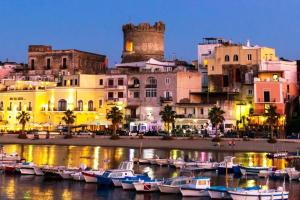 a group of boats in the water in front of buildings at Casa Marina in Forio d'Ischia