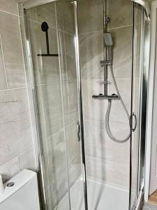 a shower with a glass door in a bathroom at Luxury at Barbizon in Barbizon