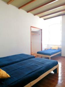 a bedroom with two beds and a mirror at Ema's Beach and Nightlife House in Lagos