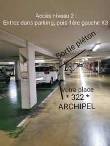 a parking lot with cars parked in a parking garage at Appartement romantique avec jacuzzi et terrasse in Perpignan