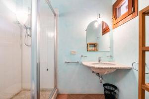 a bathroom with a sink and a shower at Residenze Coda Cavallo - Punta Aldia - Casa delle Sughere in Puntaldia +28 photos