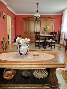 a living room with a table with a vase on it at Domek u Czesi 