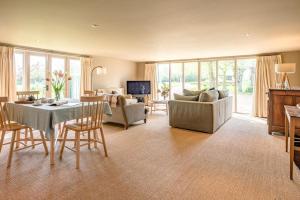 a large living room with a table and chairs at Gardiners Cottage Barn in Eye