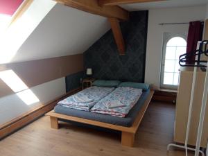 a bedroom with a bed in a attic at Ferienwohnung Schaeferhof, die Natur vor der Haustüre in Cottbus