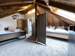 a bedroom with two beds in a attic at Haus Uhlennest in Ühlingen-Birkendorf