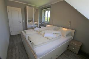 Postel nebo postele na pokoji v ubytování Fehmarnhaus 2