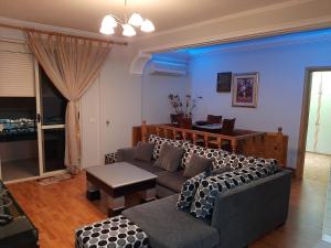 - un salon avec un canapé et une table dans l'établissement Apartament Egzoni City Center, à Berat