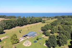 an aerial view of a park with a barn at Untere Teichwohnung in Fehmarn