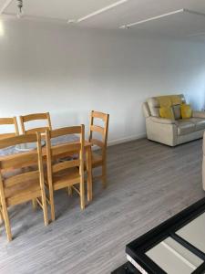 a living room with a table and chairs and a couch at 3 Bed Sleep 6, Bootle/Aintree in Bootle
