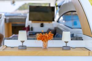 a table with two candles and a vase with flowers on it at Blue Neptune Yacht in Kas