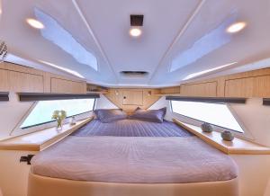 a bed in a boat with two large windows at Blue Neptune Yacht in Kaş