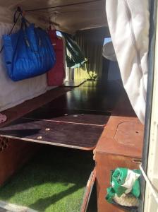 einen Blick auf einen Wohnwagen mit 2 Betten und einem Tisch in der Unterkunft Tenerife Van Mercedes for drive in Canary island in Adeje