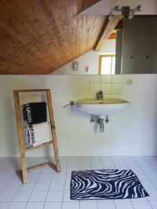 a bathroom with a sink and a zebra rug at Seepanoramablick in Gmunden
