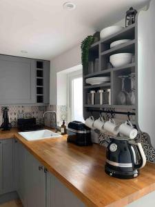 a kitchen with a counter top with a tea kettle on it at The Pink House in Falmouth