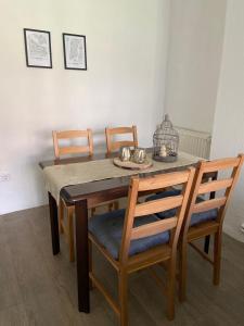 a dining room table with chairs and a bird cage on it at Ferienwohnung am Friedenspark 2 in Thale +3 photos