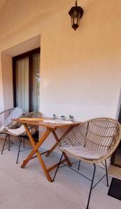 a wooden table with two chairs and a lamp at Apartaments Victoria in Poreč
