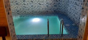 a swimming pool in a room with a tile wall at Barda in Vorokhta