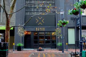 a black brick building with a black and gold store at BlackBrick Cape Town Foreshore in Cape Town