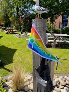 a bird sitting on top of a wooden post at WH Hotels Papenburg Zentrum in Papenburg