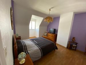 a bedroom with a bed and a tv in it at TELLA in Ploemeur