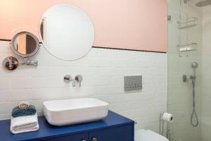 a bathroom with a sink and a mirror at TLV beach 4 rooms big balcony / 125 m2 appart in Tel Aviv