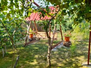 a tree house in the middle of a garden at Casa Dan in Tuzla