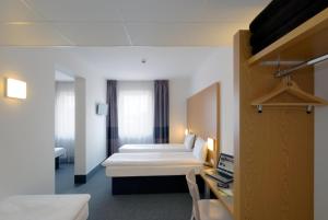 Postel nebo postele na pokoji v ubytování B&B Hotel Prague City